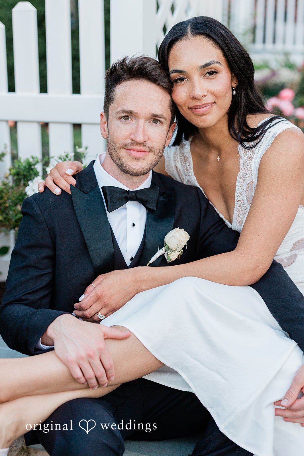 Bride and groom posing together while seated at Chicago Backyard