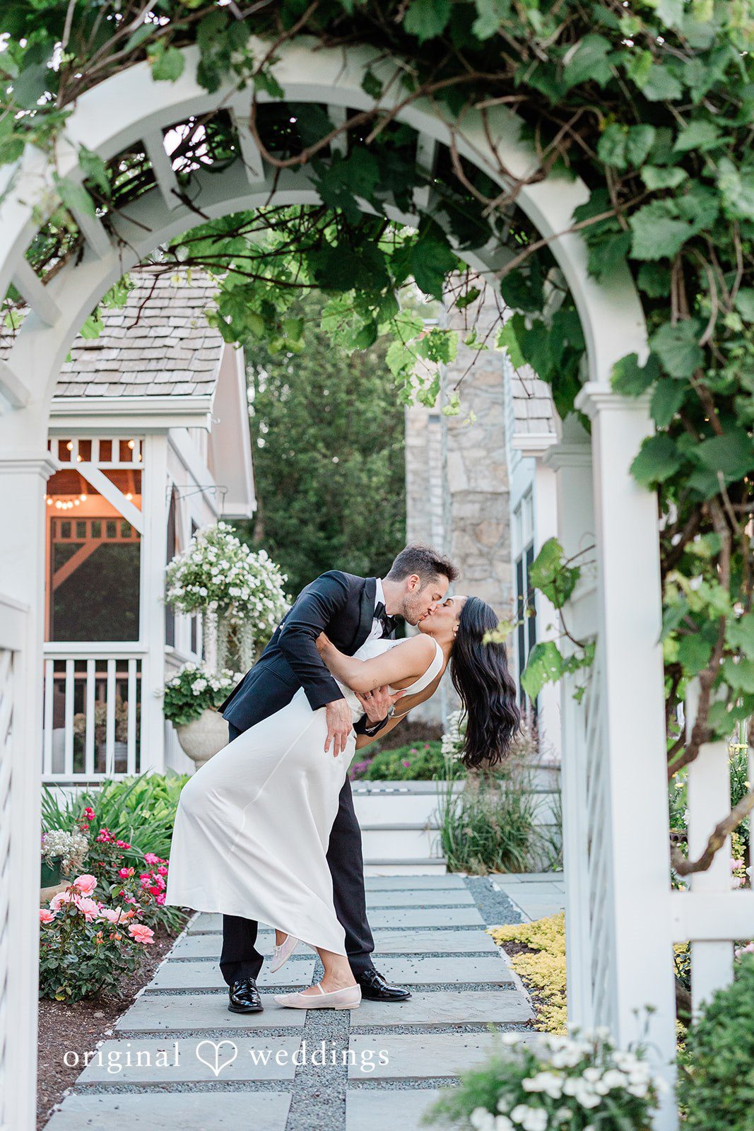 Groom lifting the bride while kissing her at Chicago Backyard