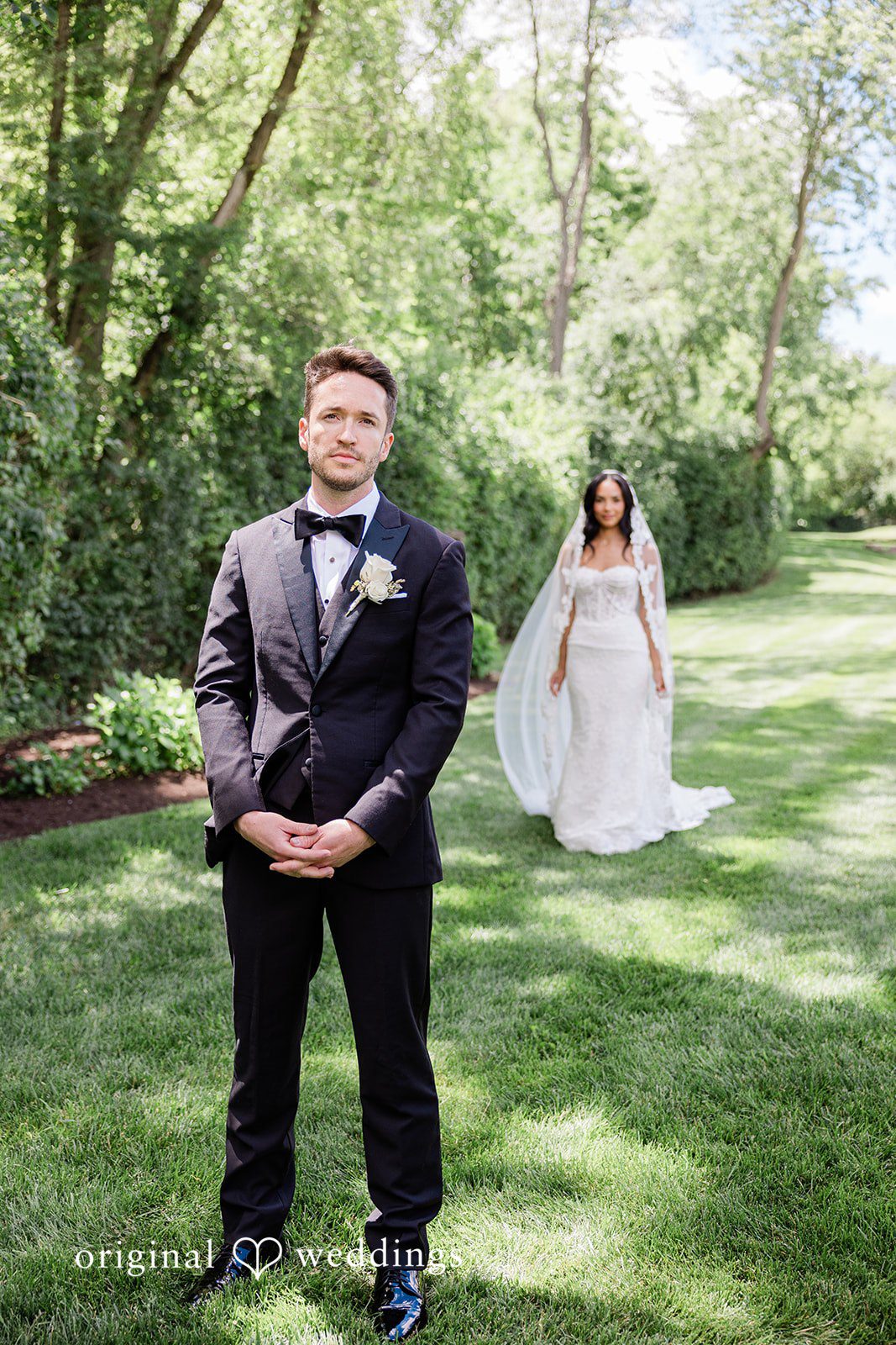 Groom standing while the bride stands behind him at Chicago Backyard
