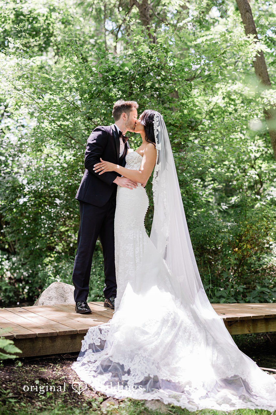 Bride and groom kissing during their portrait session at Chicago Backyard