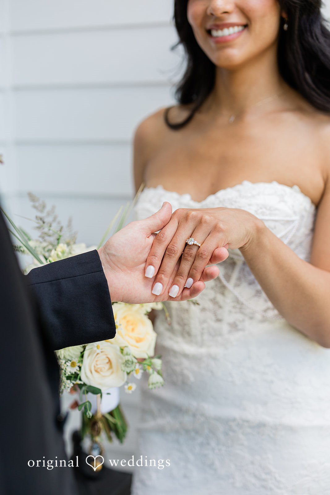 Groom holding the bride's hand with a close-up of the wedding ring at Chicago Backyard