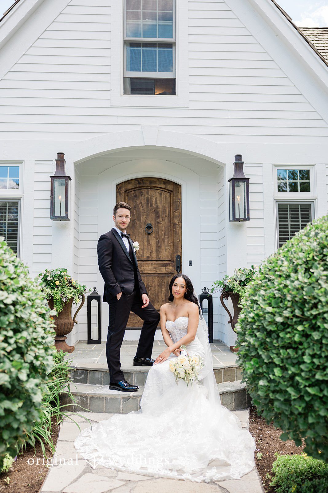 Groom standing as the bride sits on the stairs at Chicago Backyard