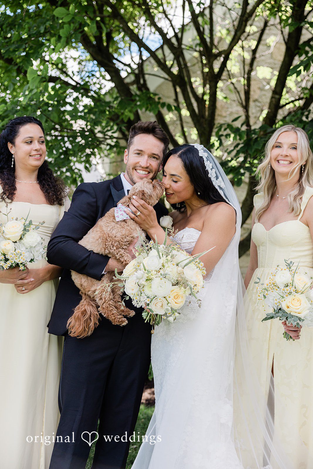 Couple sharing a sweet moment with their puppy at Chicago Backyard