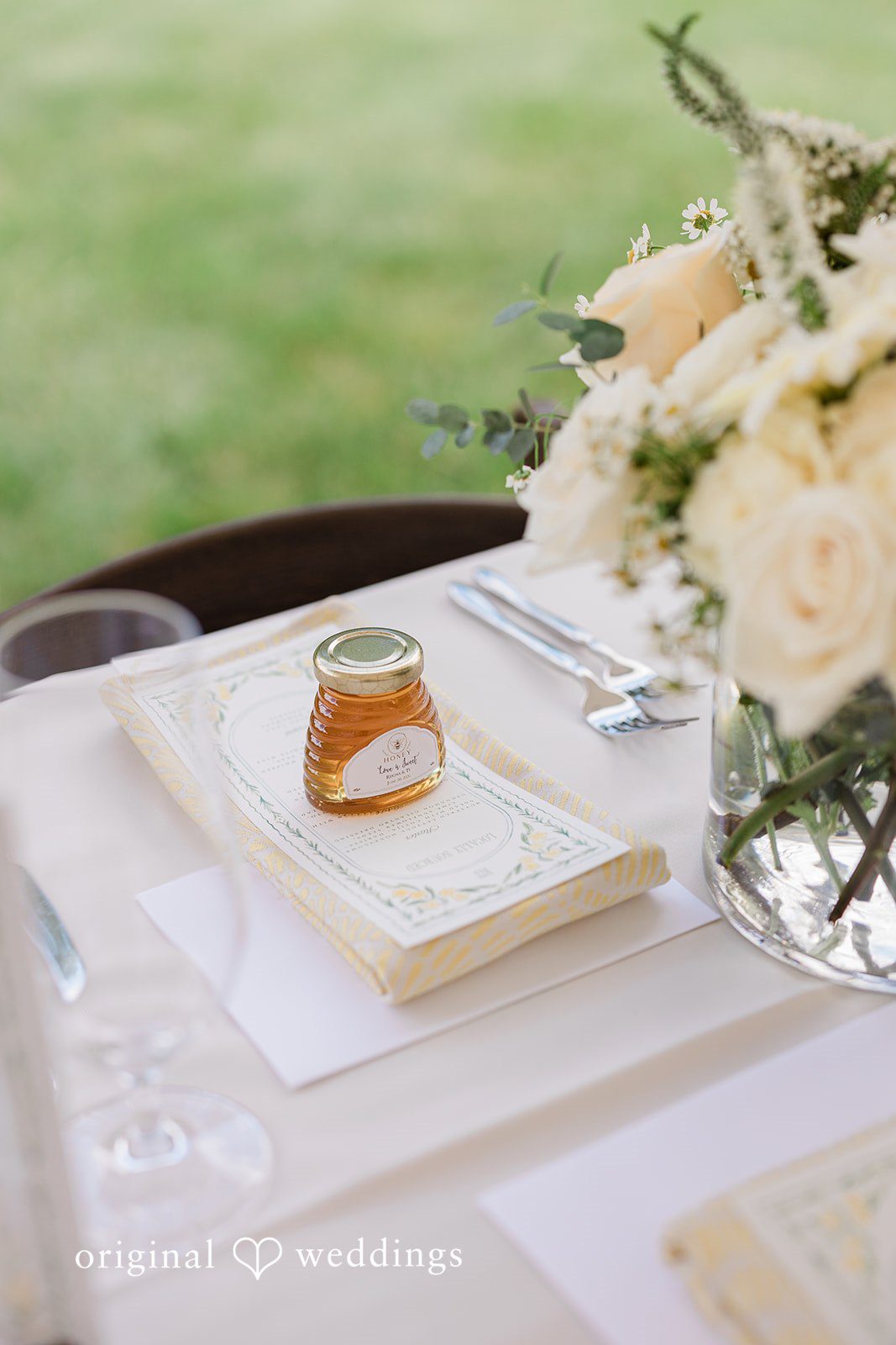 Reception table decorated with flowers in a vase at Chicago Backyard