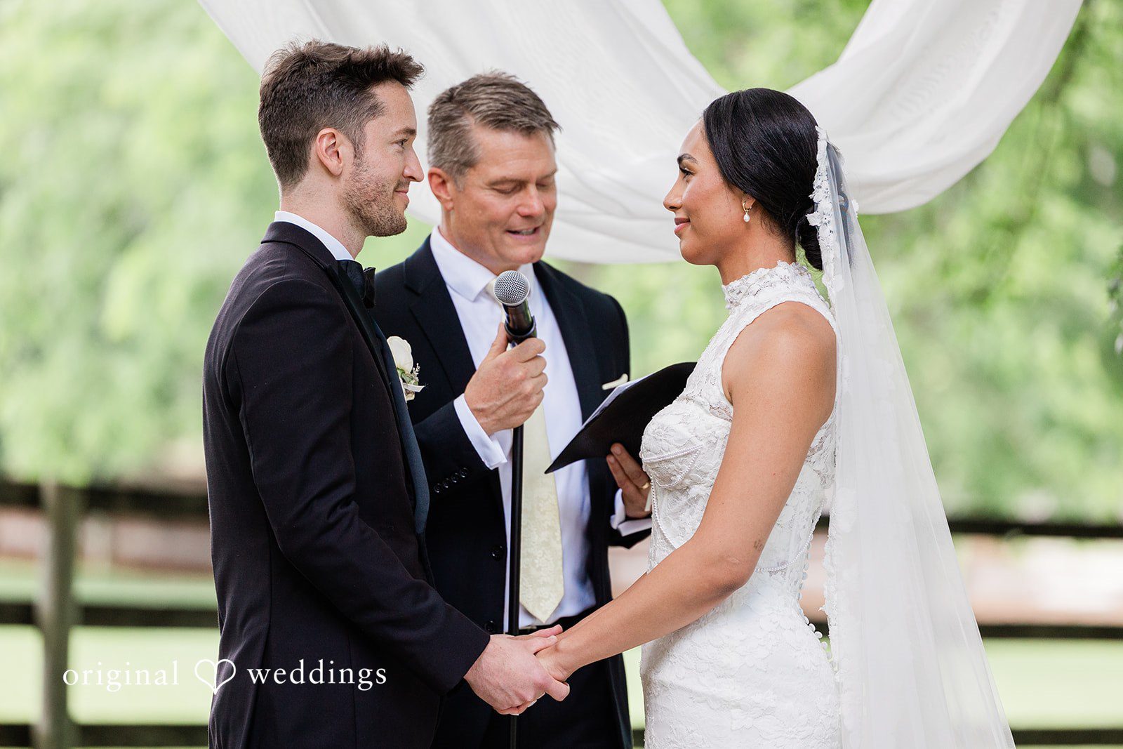Couple holding hands while looking into each other's eyes at Chicago Backyard