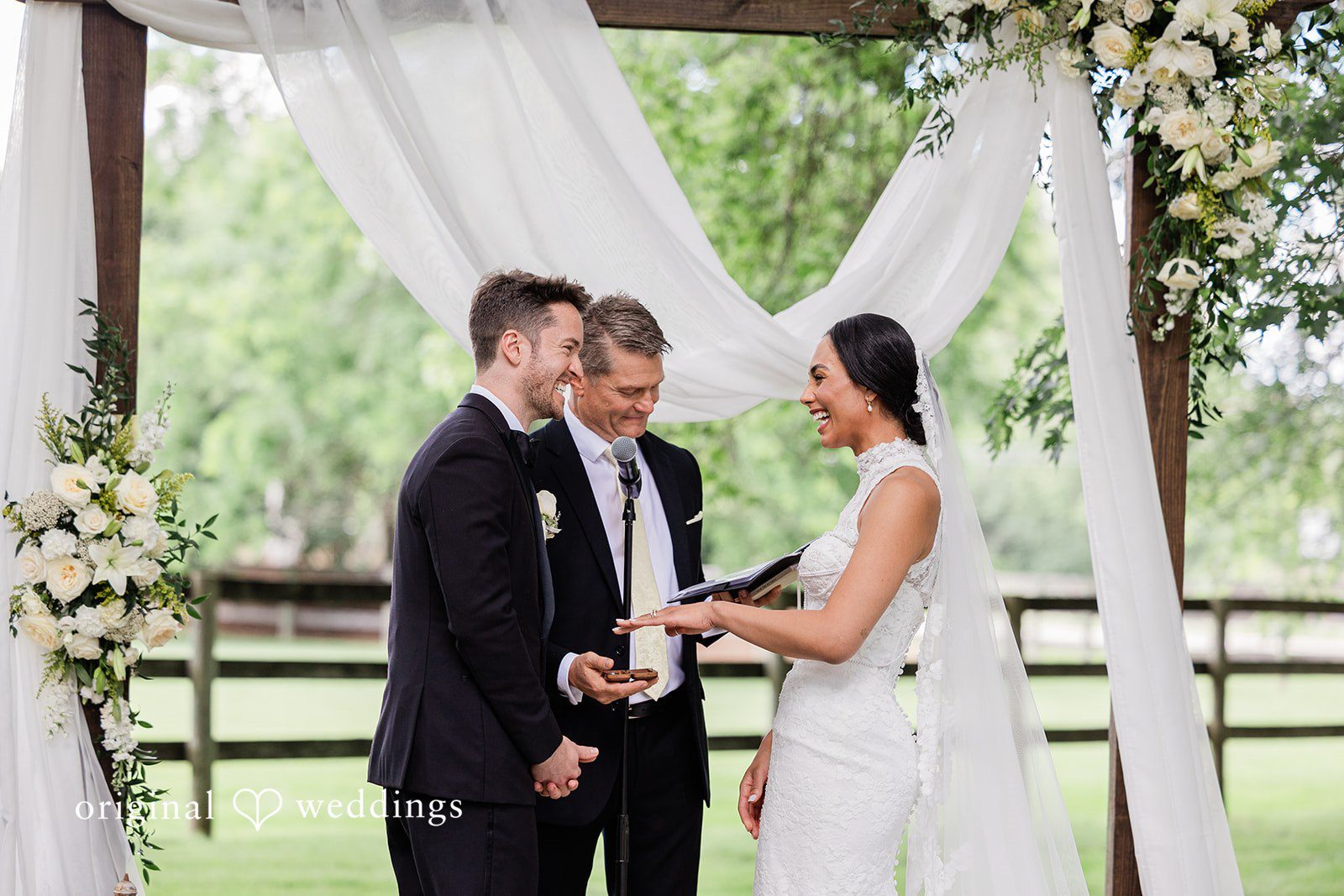 Couple looking into each other's eyes while showing ring  at Chicago Backyard