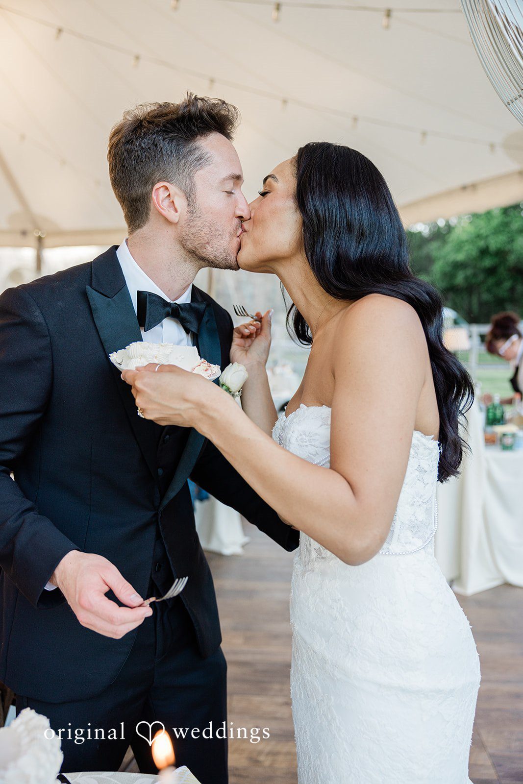Couple kissing while feeding cake to each other at Chicago Backyard