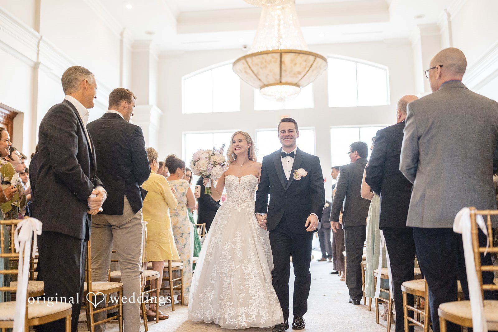 Emily + Jacob Our Boston wedding photographers captured the moment the couple made a joyful exit after their wedding ceremony