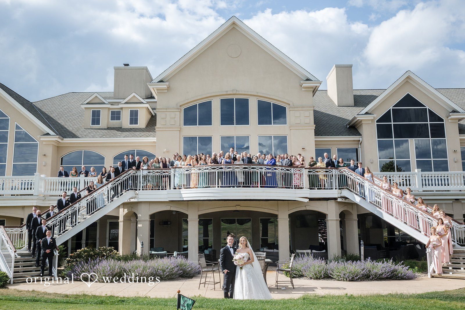 Emily + Jacob A stylish portrait of the couple and their wedding party at the Indian Pond Country Club