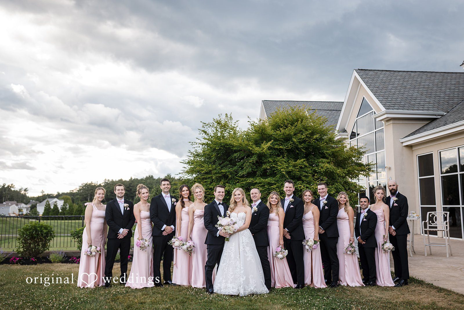 Emily + Jacob A beautiful portrait of the couple and their bridal party at the Indian Pond Country Club