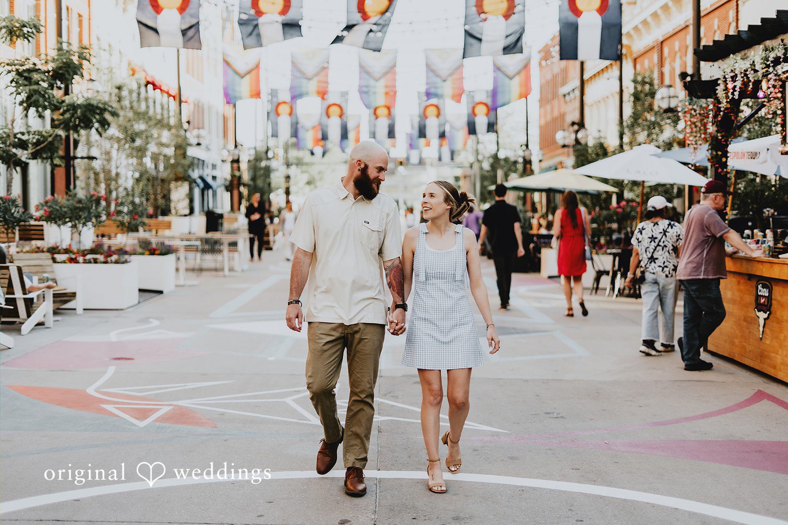Courtney + Seth Our Denver wedding photographers at Original Weddings captured the couple taking a walk at Larimer Square
