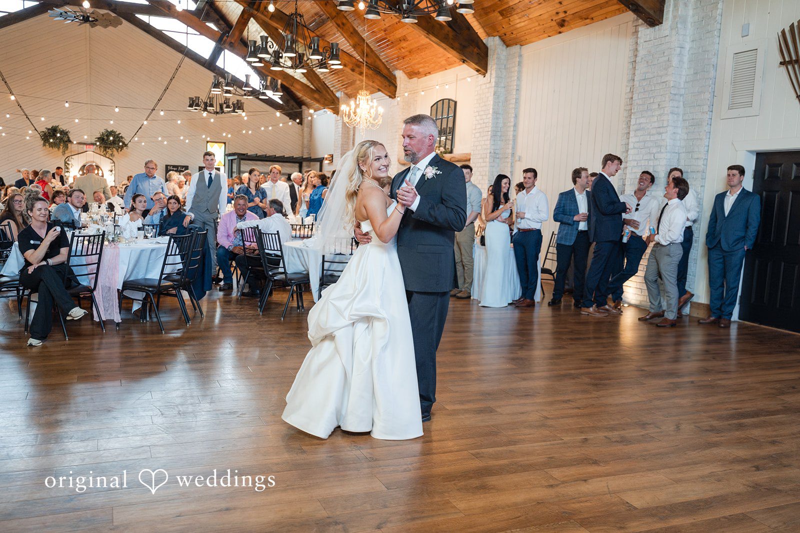 Cassandra + Adam Bride and man dancing together in the center of the reception hall.