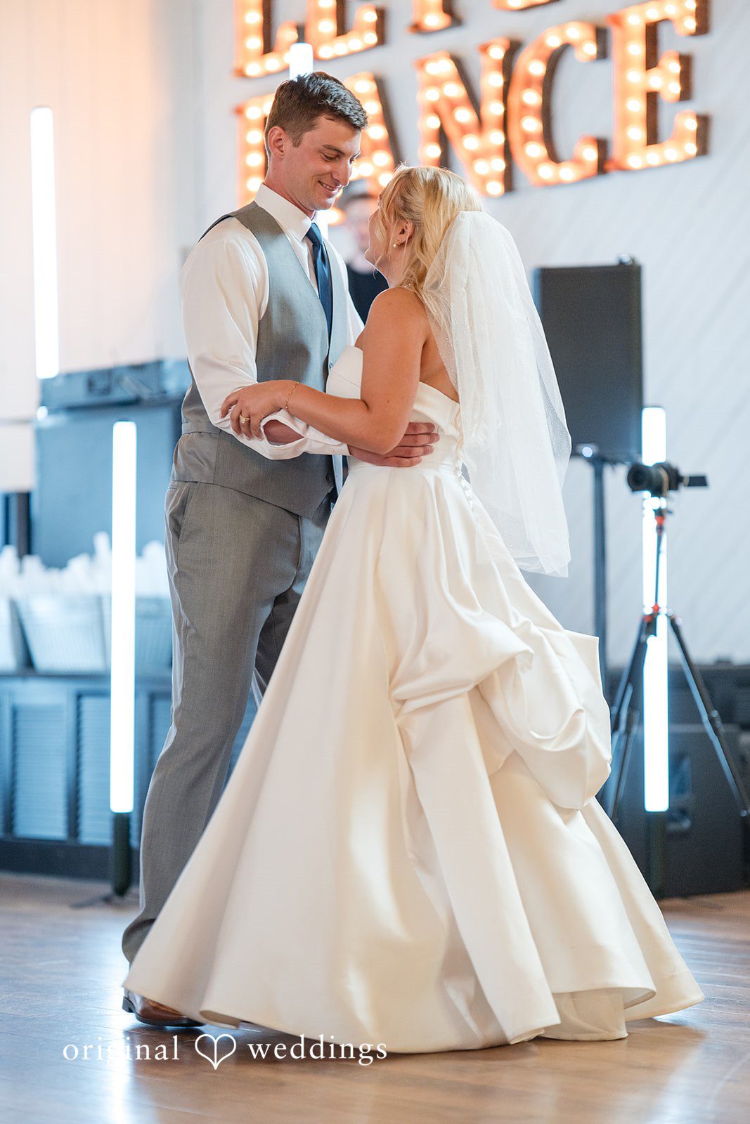 Cassandra + Adam Close shot of the bride and groom dancing with a large "DANCE" sign behind them.