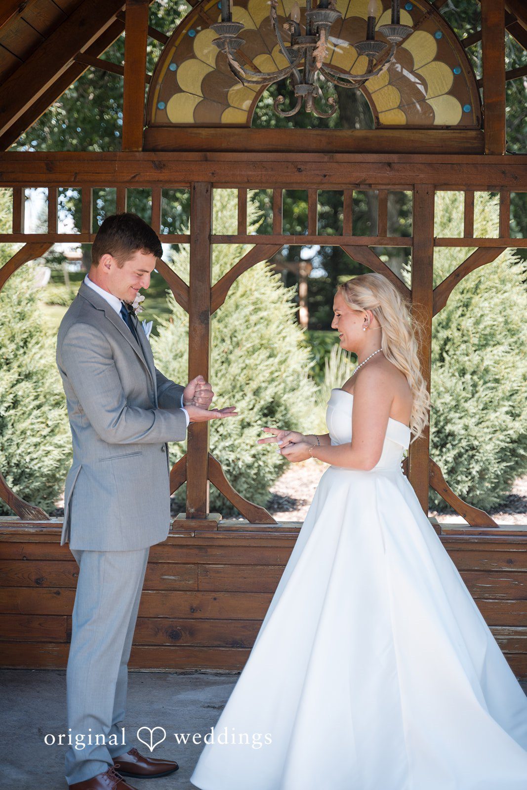 Cassandra + Adam Groom holding out his hand toward the bride as she smiles at him.