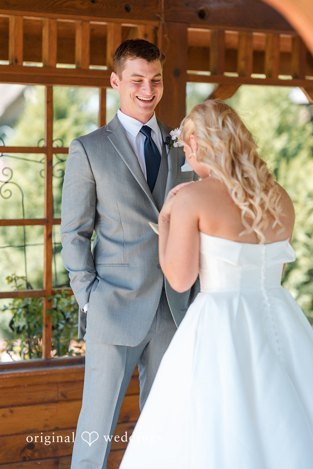 Cassandra + Adam Groom looking down and smiling while holding hands with the bride.