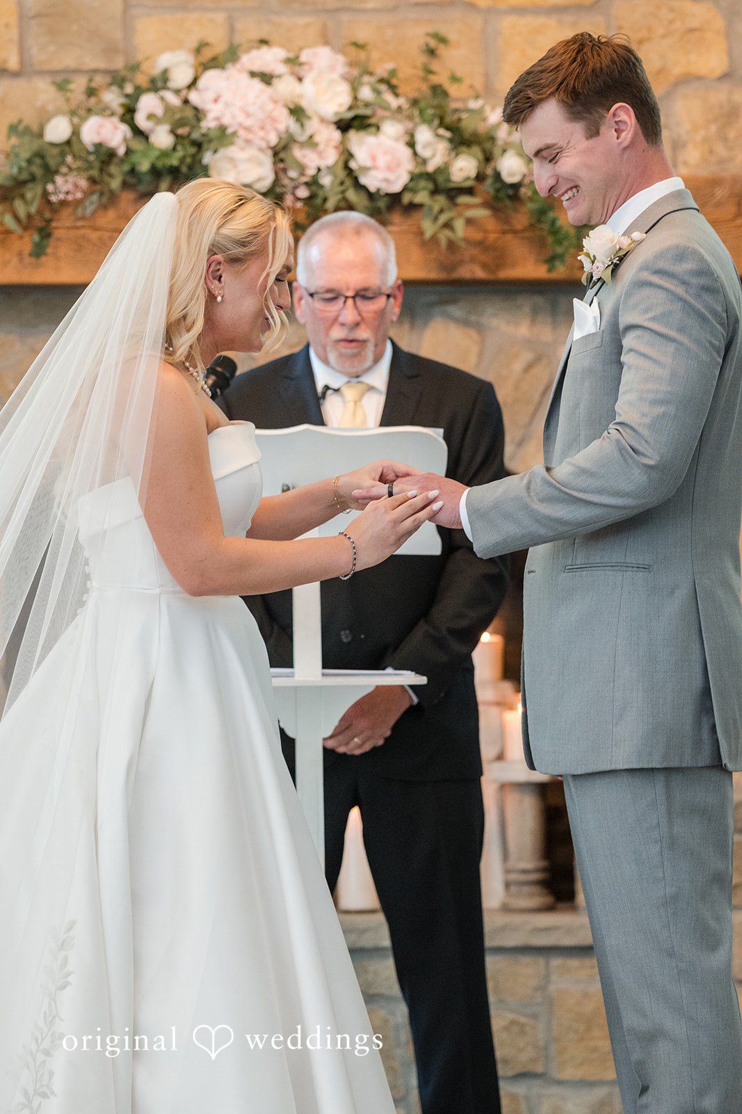 Cassandra + Adam Groom placing a wedding ring onto the bride's finger at the altar.