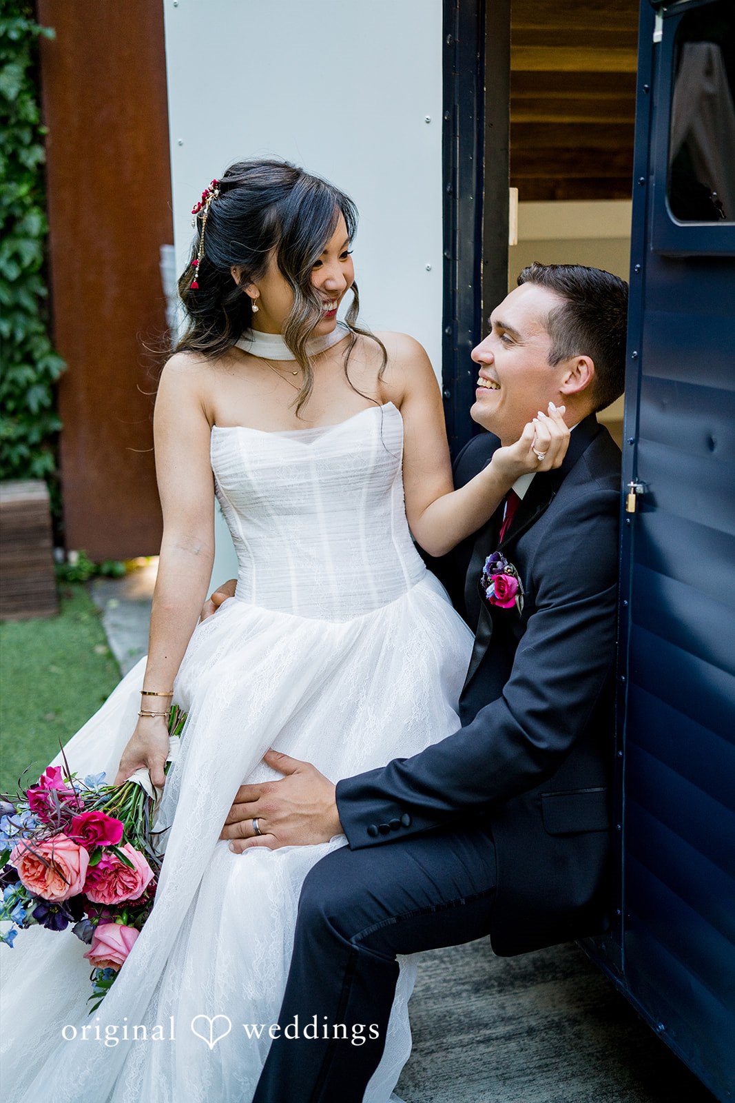Bride sitting on groom's lap while looking at each other at Lytle House