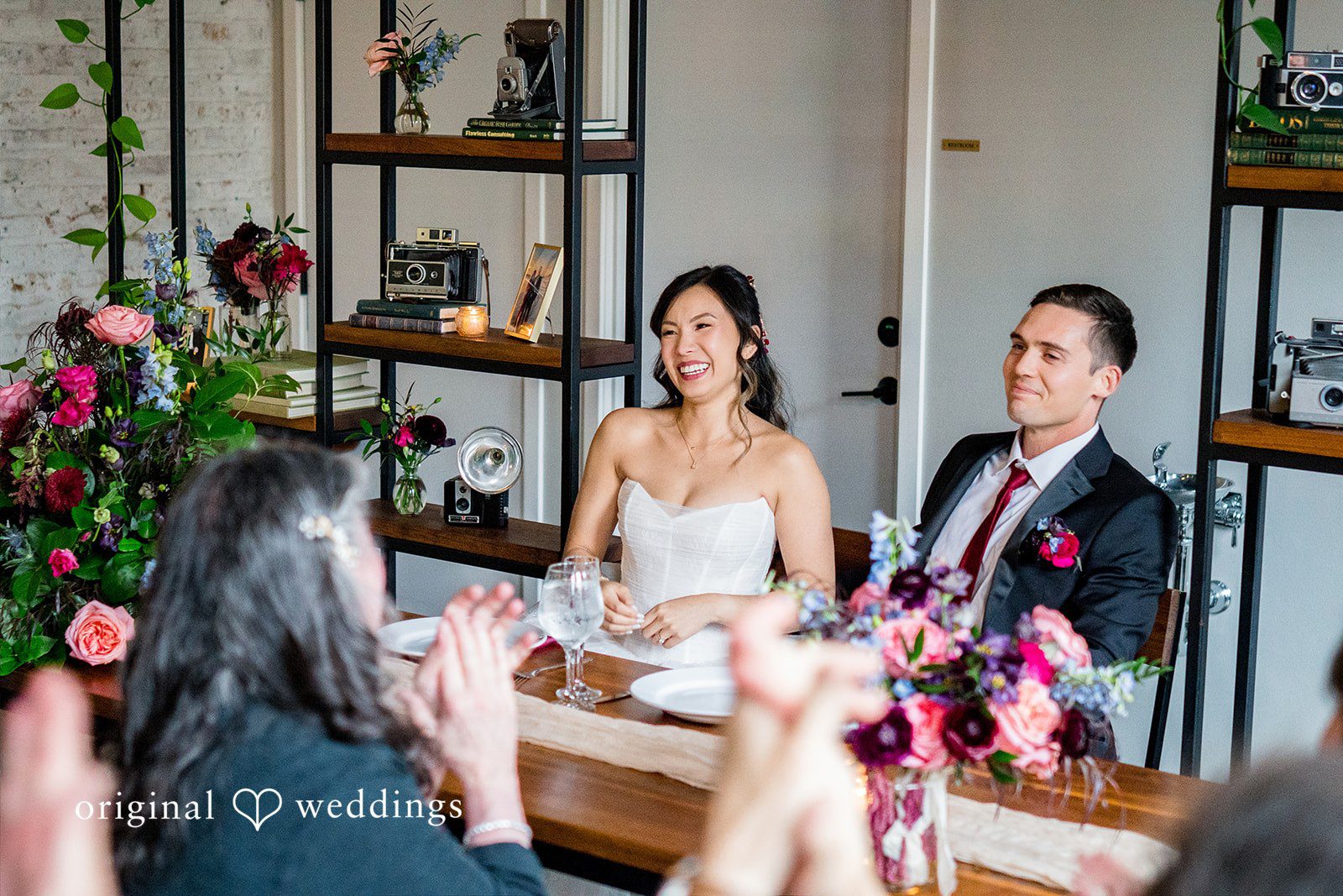Bride and groom enjoying  at the reception table at Lytle House