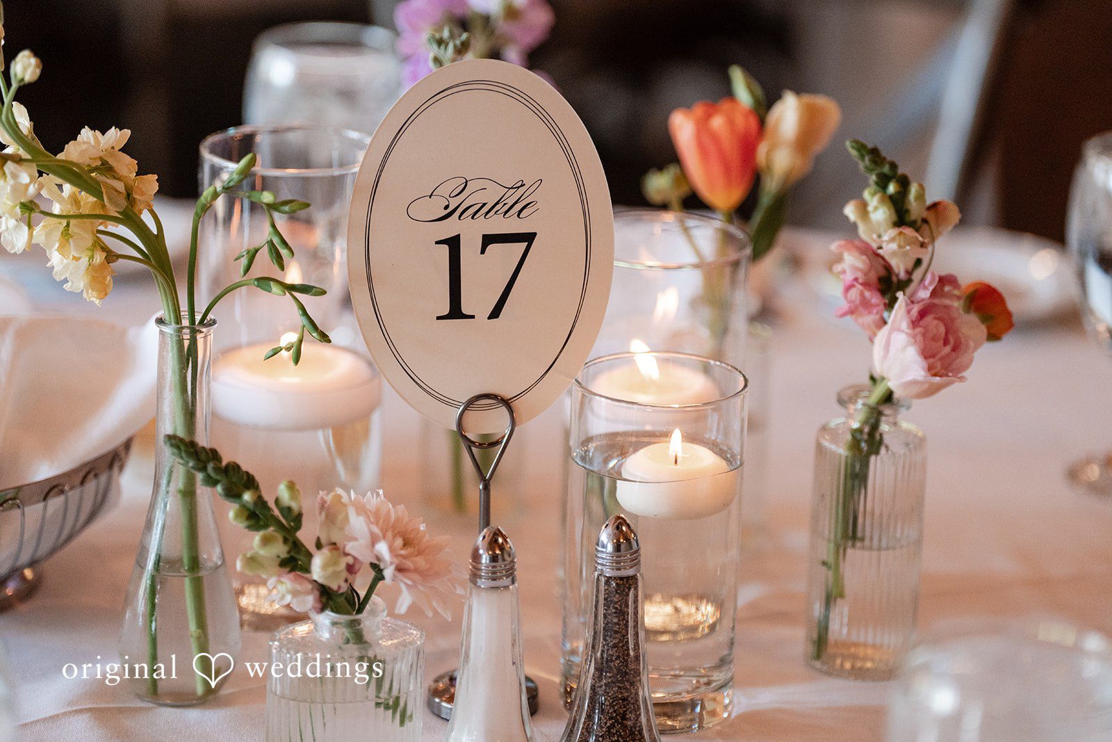 Annie + Andrew Close up of wedding table number 17 decorated with flowers and candles