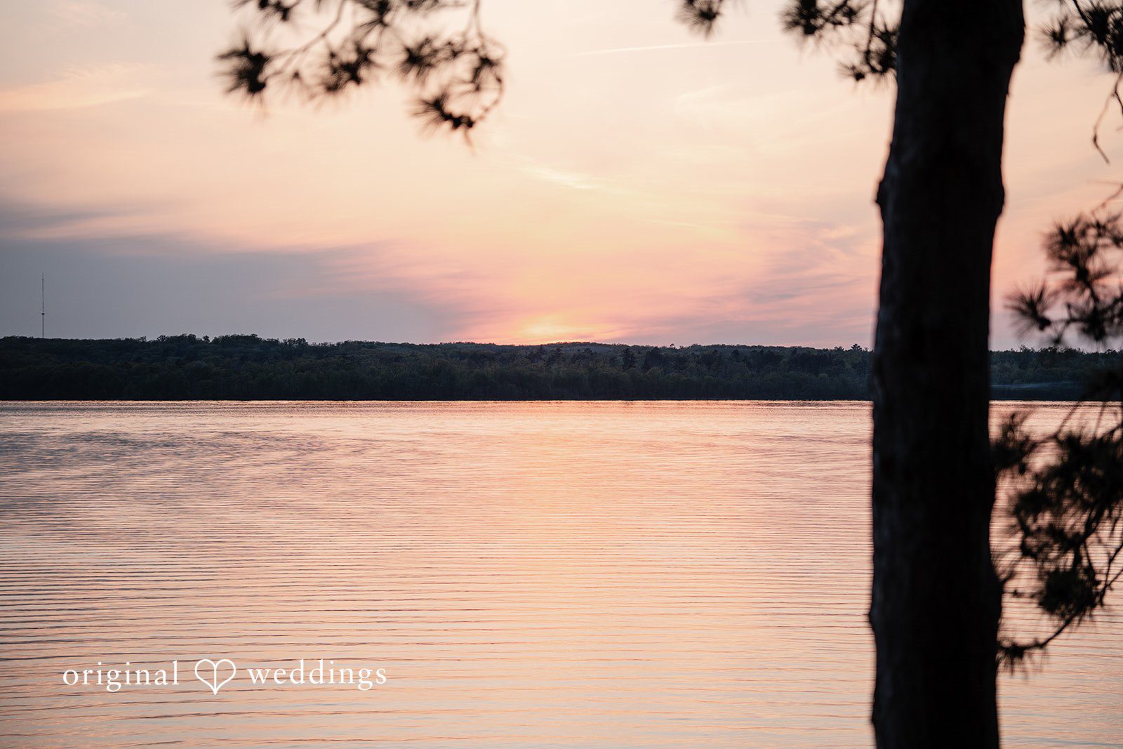 Annie + Andrew Amazing sunset view over water captured by team of Original Weddings