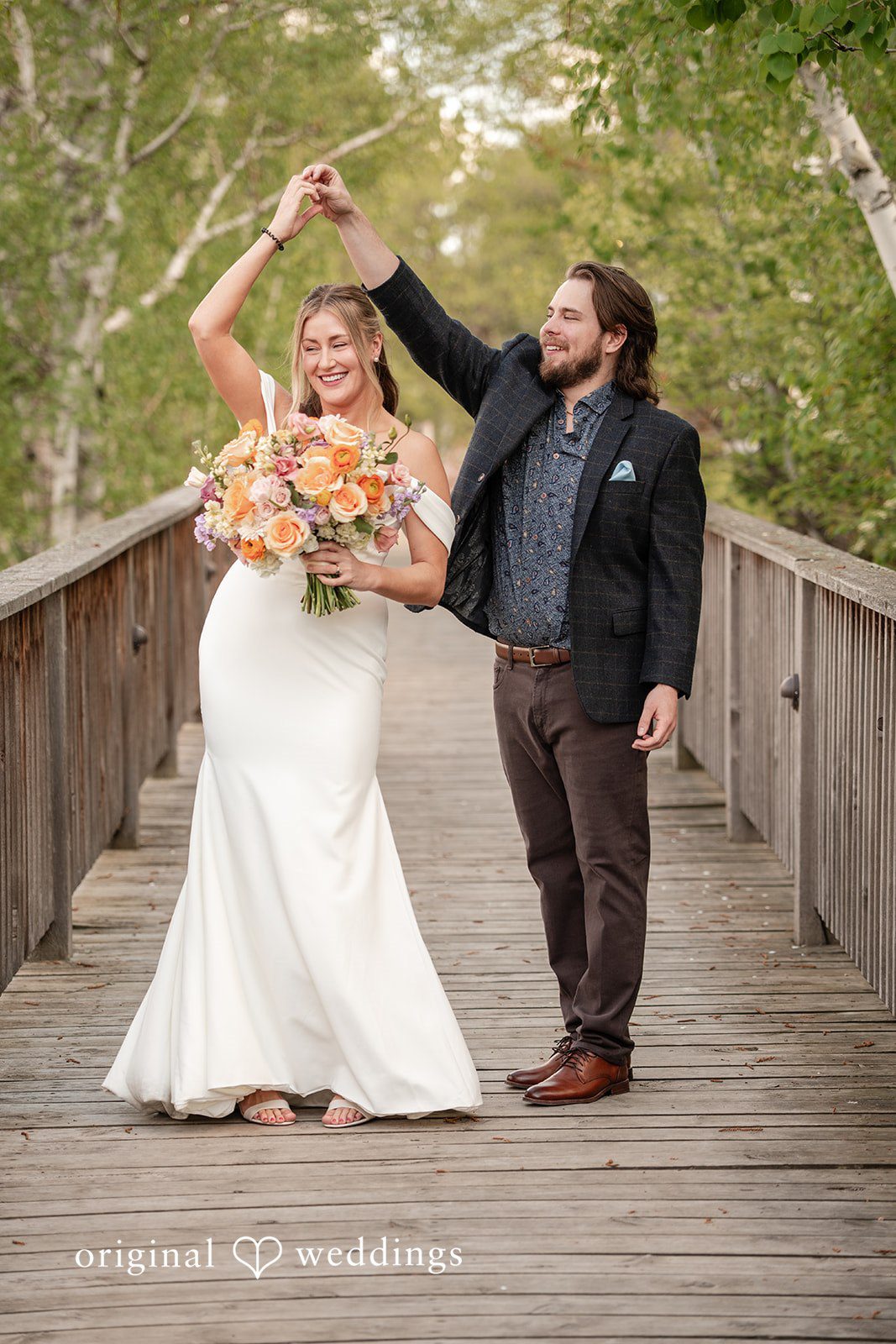 Annie + Andrew Bride twirling around the groom at Madden's On Gull Lake