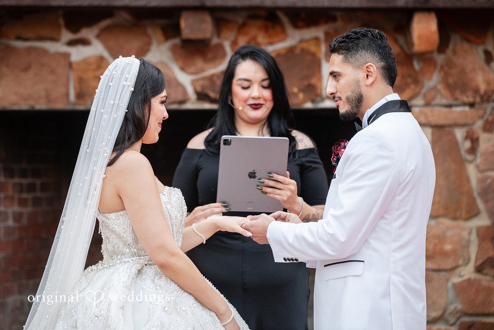 Vanessa + Abdelrahman The groom puts a ring on the groom's finger