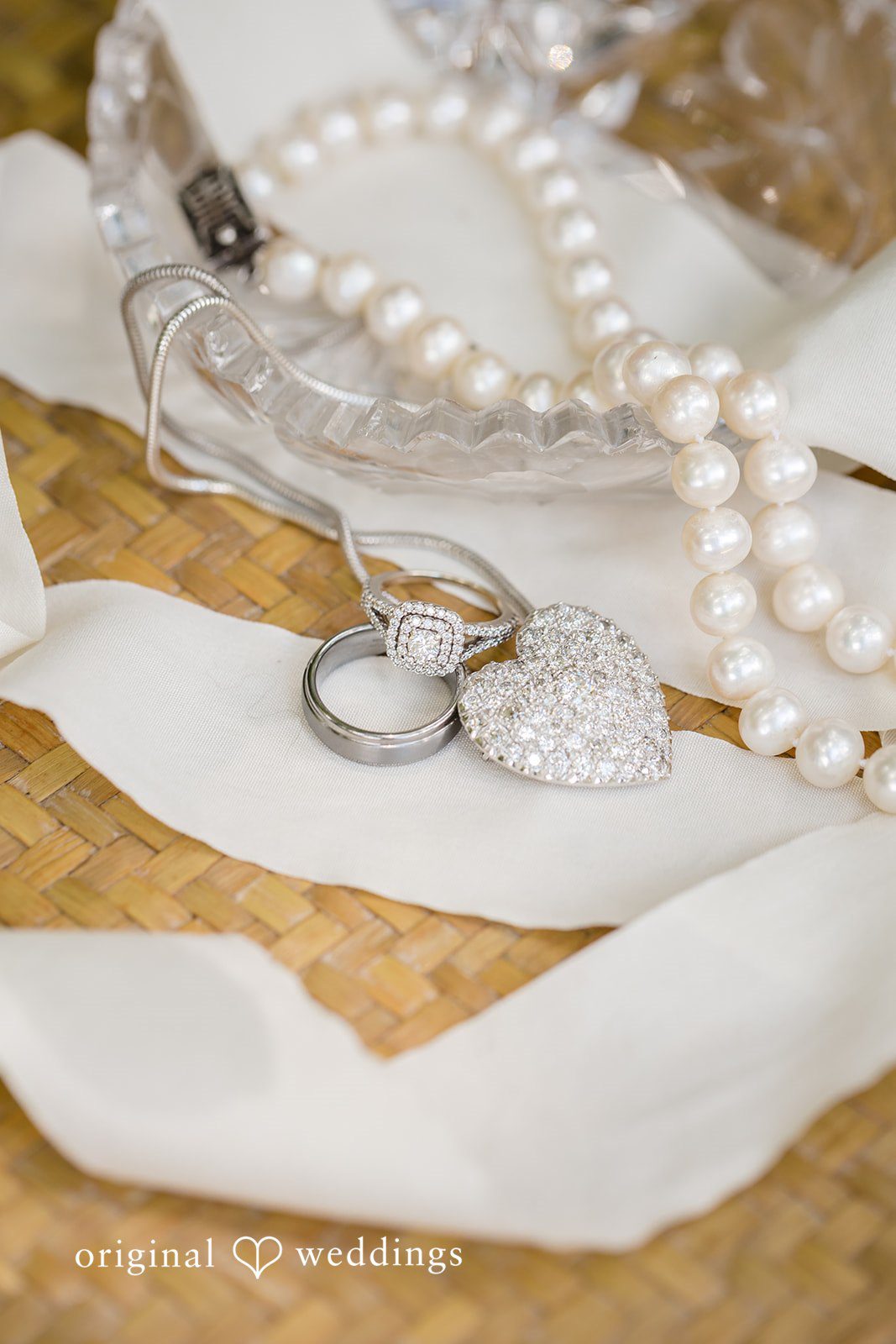 Madison + Aiden Romantic wedding rings displayed with pearl jewelry and bridal accessories