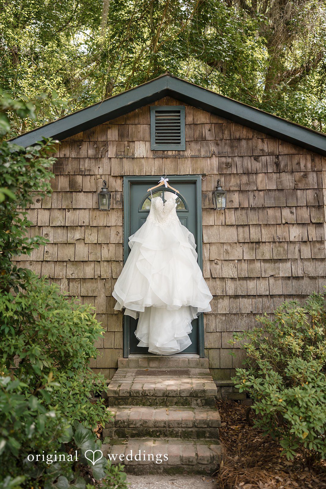 Madison + Aiden Romantic wedding dress detail surrounded by lush greenery