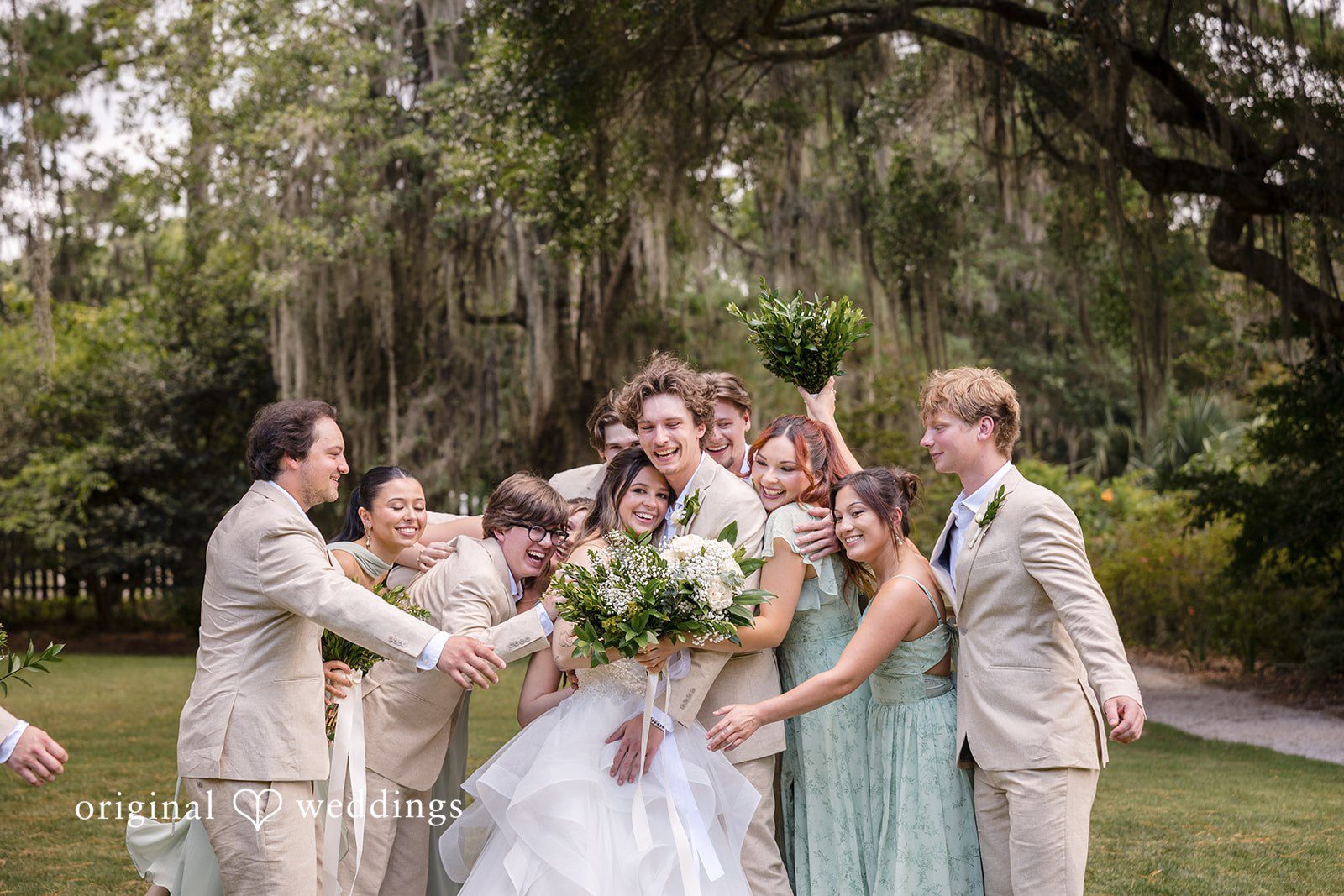 Madison + Aiden Full bridal party celebrating outdoors in the beautiful gardens of Magnolia Plantation and Gardens captured by Charleston Wedding Photographers from Original Weddings