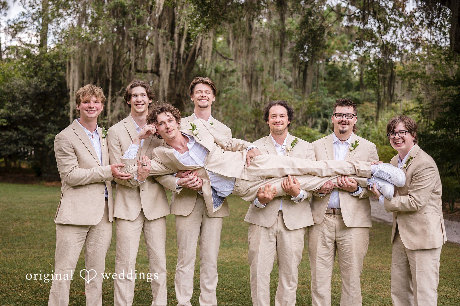 Madison + Aiden Groom and groomsmen sharing laughs outdoors before the ceremony