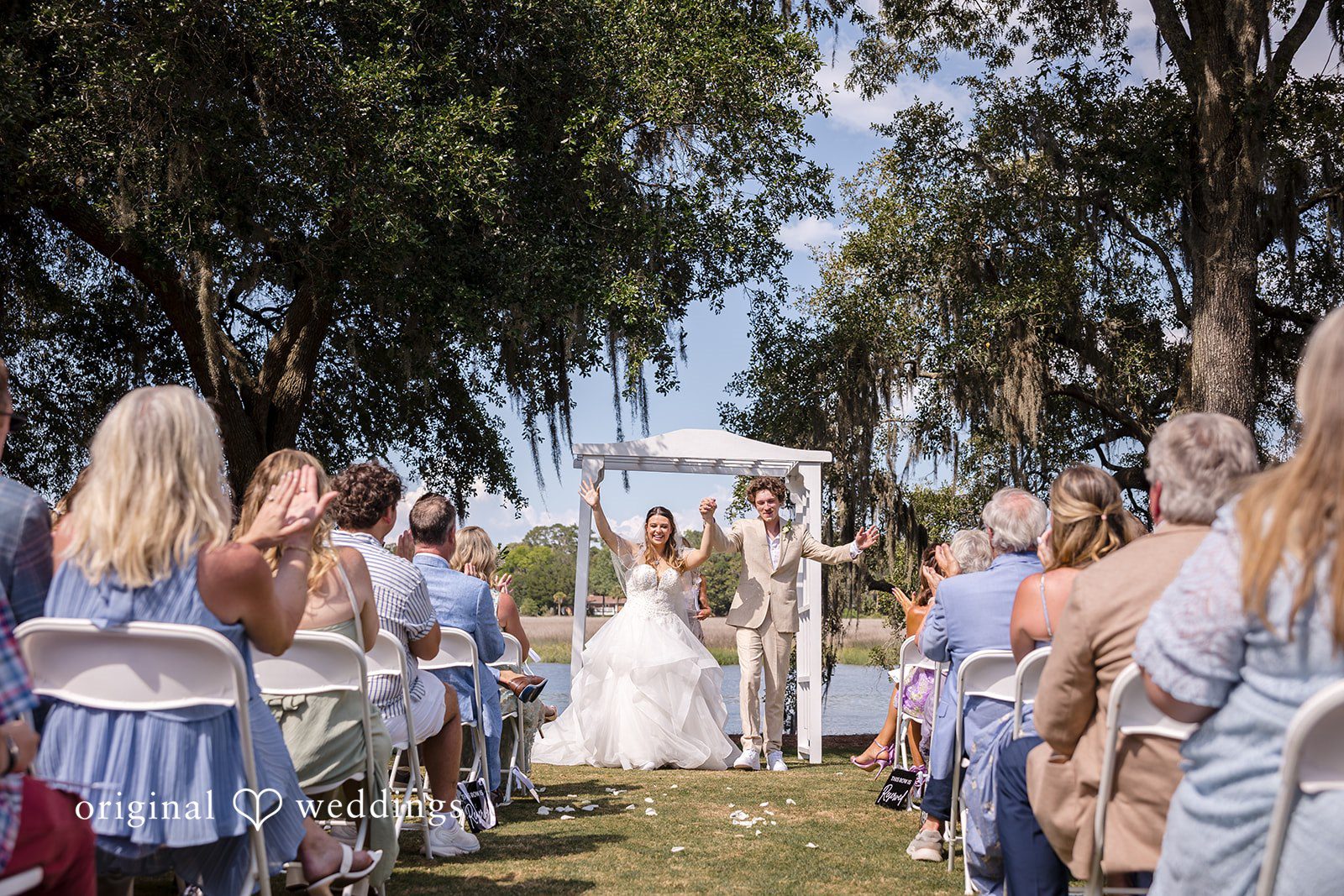 Madison + Aiden Newlyweds celebrating after the ceremony at Magnolia Plantation and Gardens captured by Charleston Wedding Photographers from Original Weddings