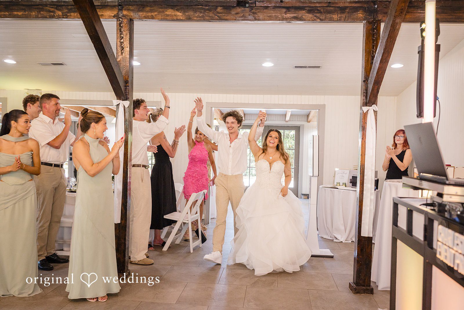 Madison + Aiden Bride and groom making their joyful reception entrance at Magnolia Plantation and Gardens