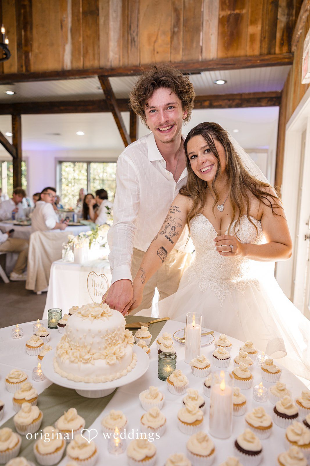 Madison + Aiden Bride and groom cutting their elegant wedding cake during the reception at Magnolia Plantation and Gardens.