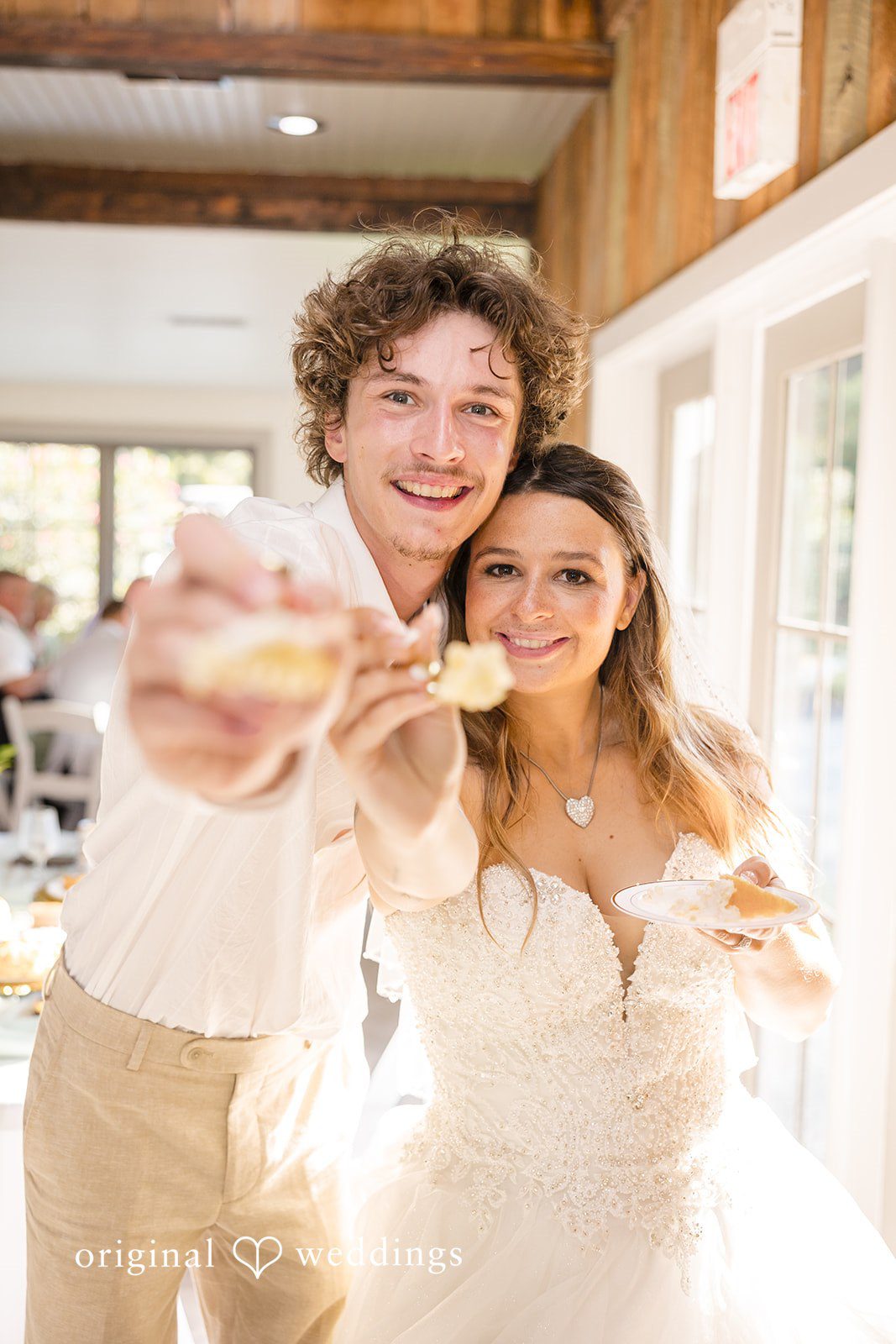 Madison + Aiden Newlyweds sharing a fun cake moment