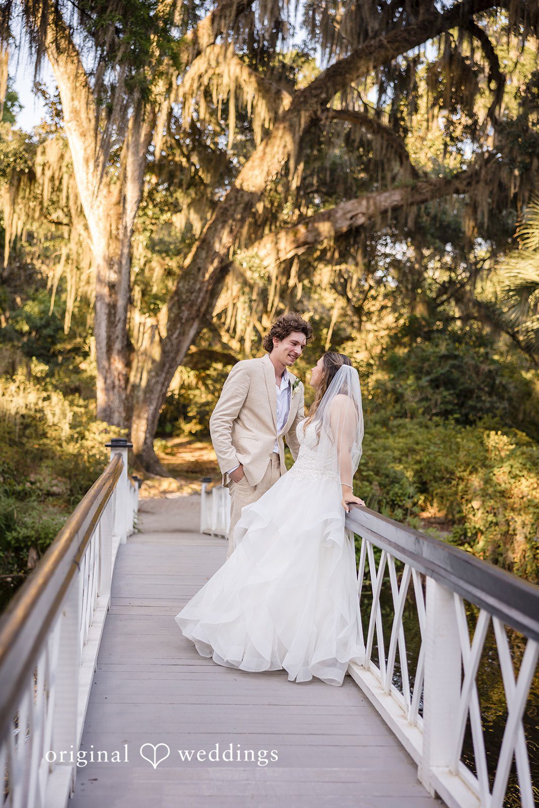 Madison + Aiden Bride and groom sharing a romantic moment on the white bridge at Magnolia Plantation and Gardens