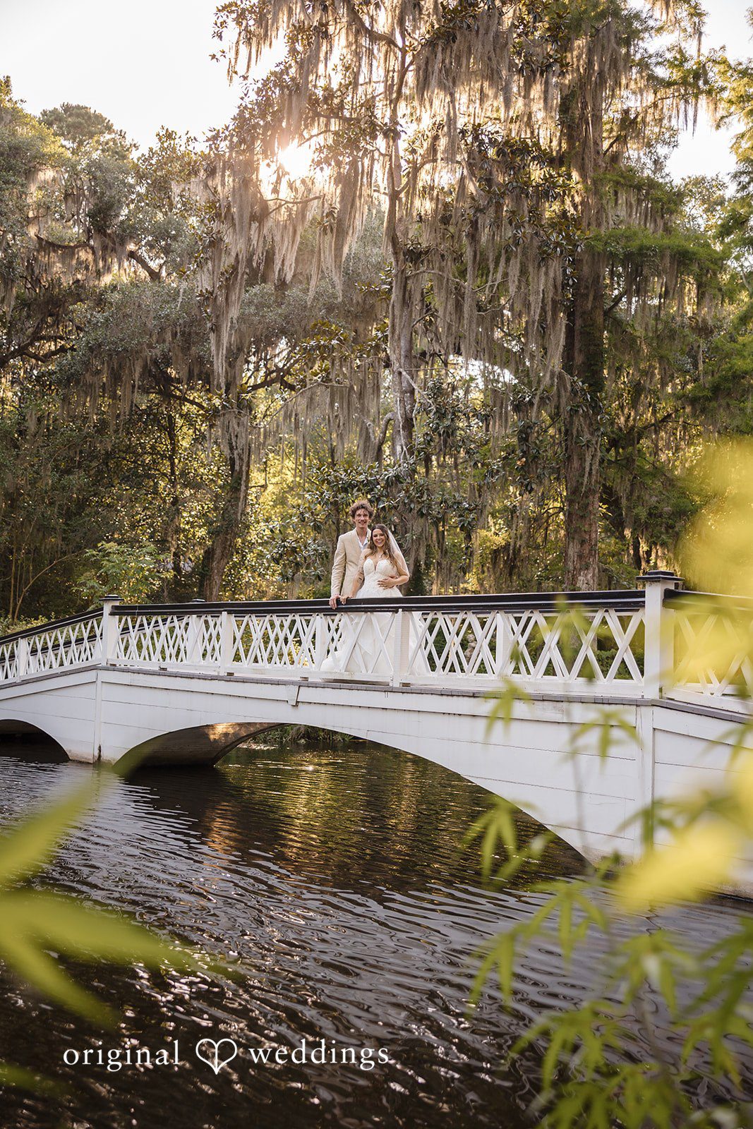 Madison + Aiden Bride and groom enjoying a peaceful moment overlooking the water at Magnolia Plantation and Gardens.