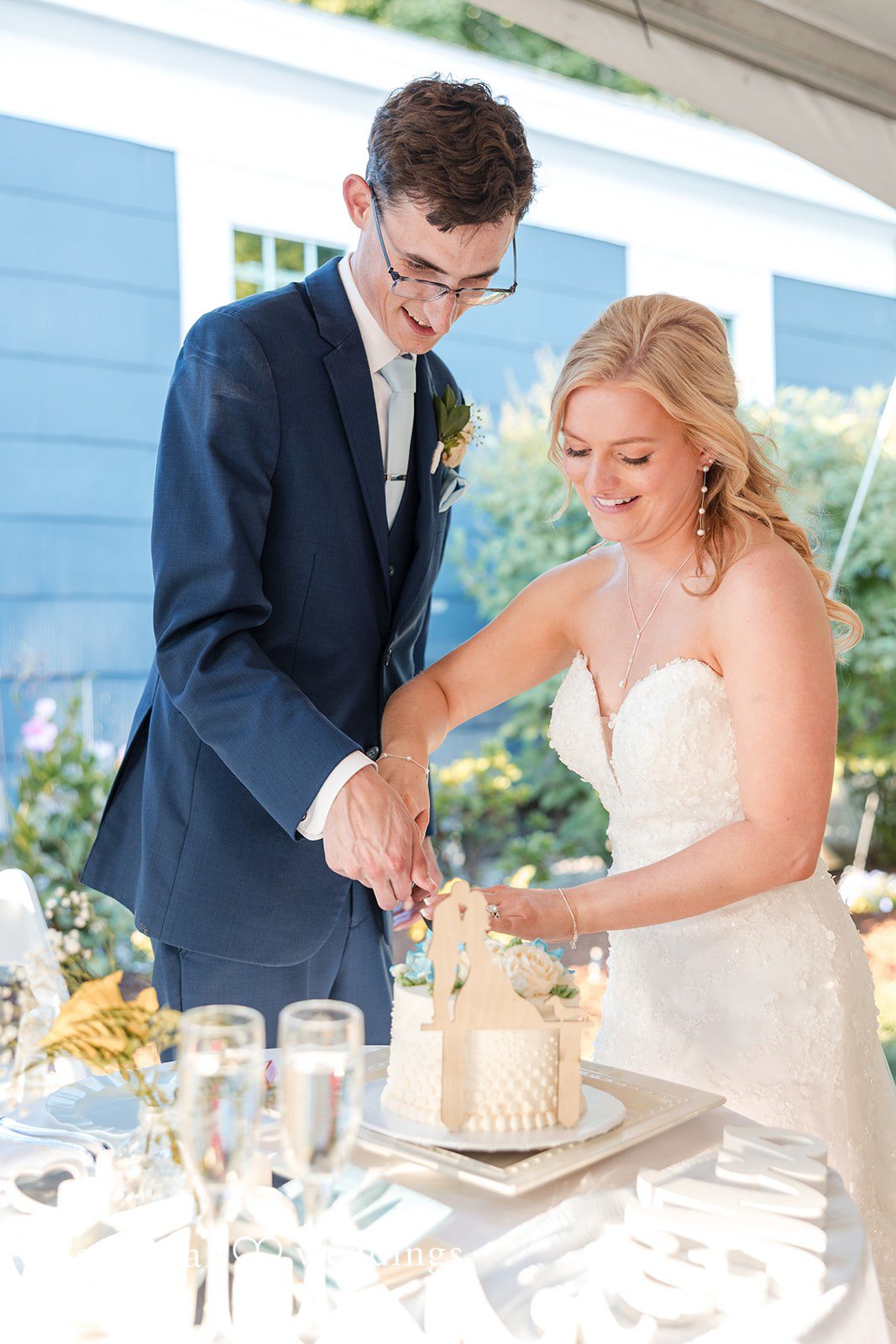 John + Emma Bride and groom cutting their wedding cake.