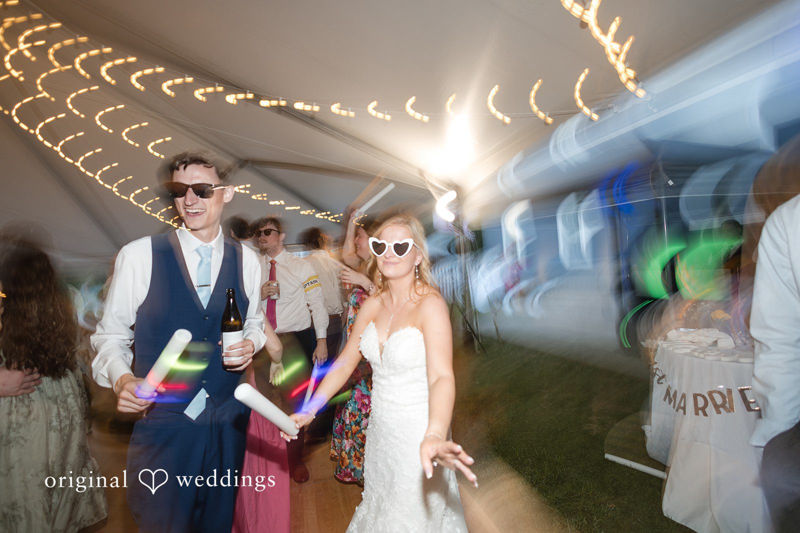 John + Emma Bride and groom wearing glow sticks while dancing.