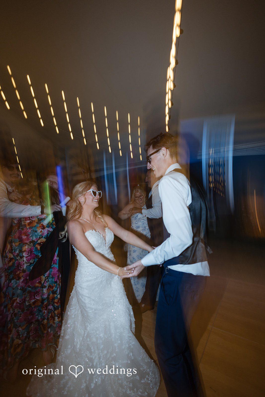 John + Emma Blurry motion shot of the bride and groom dancing energetically.