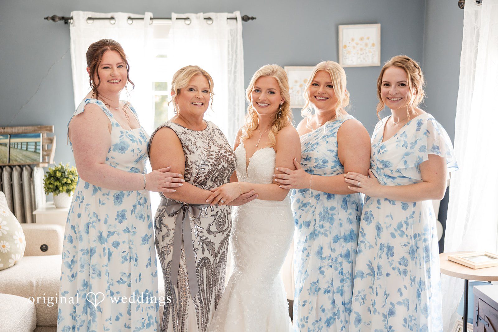 John + Emma Bride posing with four bridesmaids wearing matching light blue gowns.