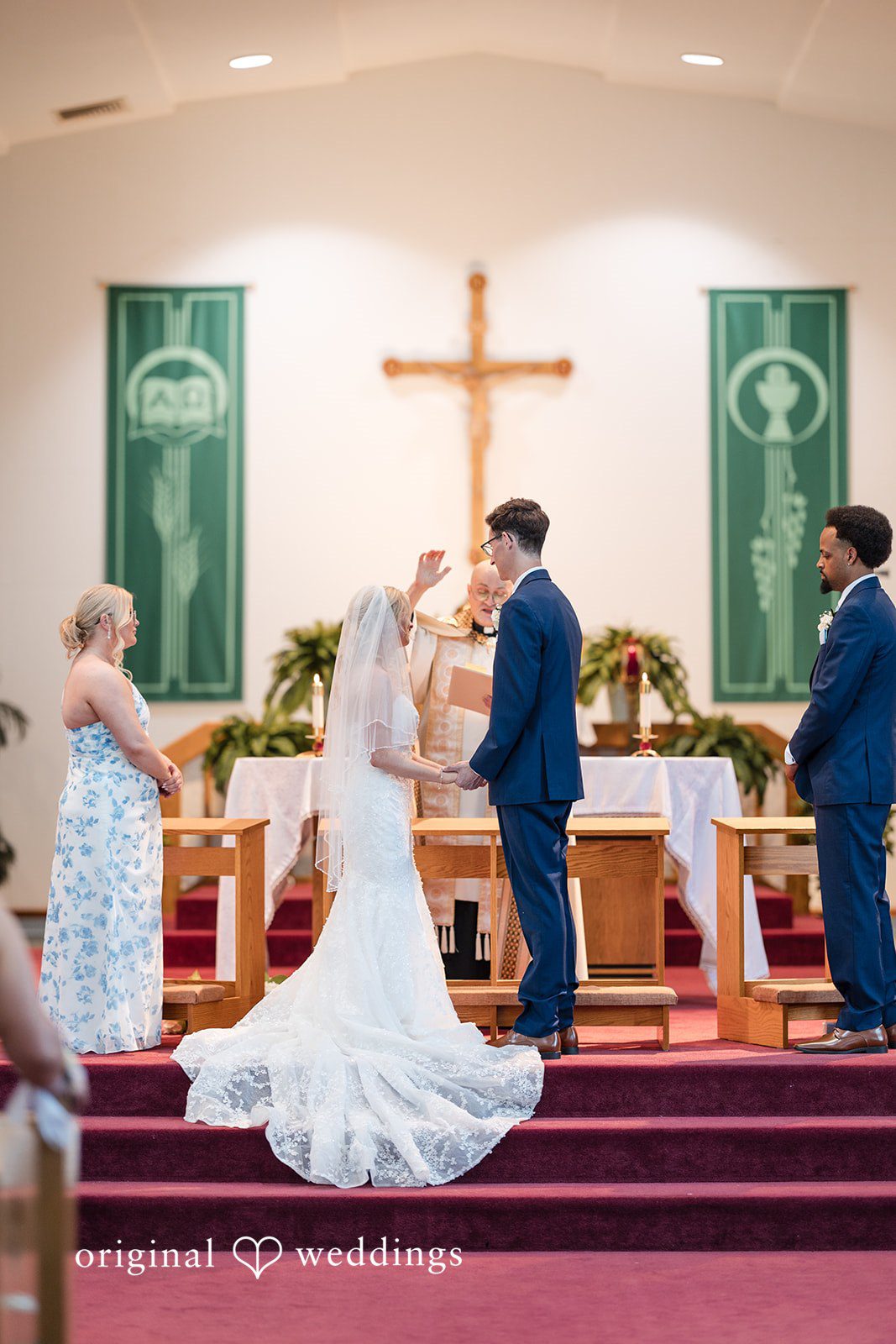 John + Emma Wide shot of a church wedding ceremony at the altar.