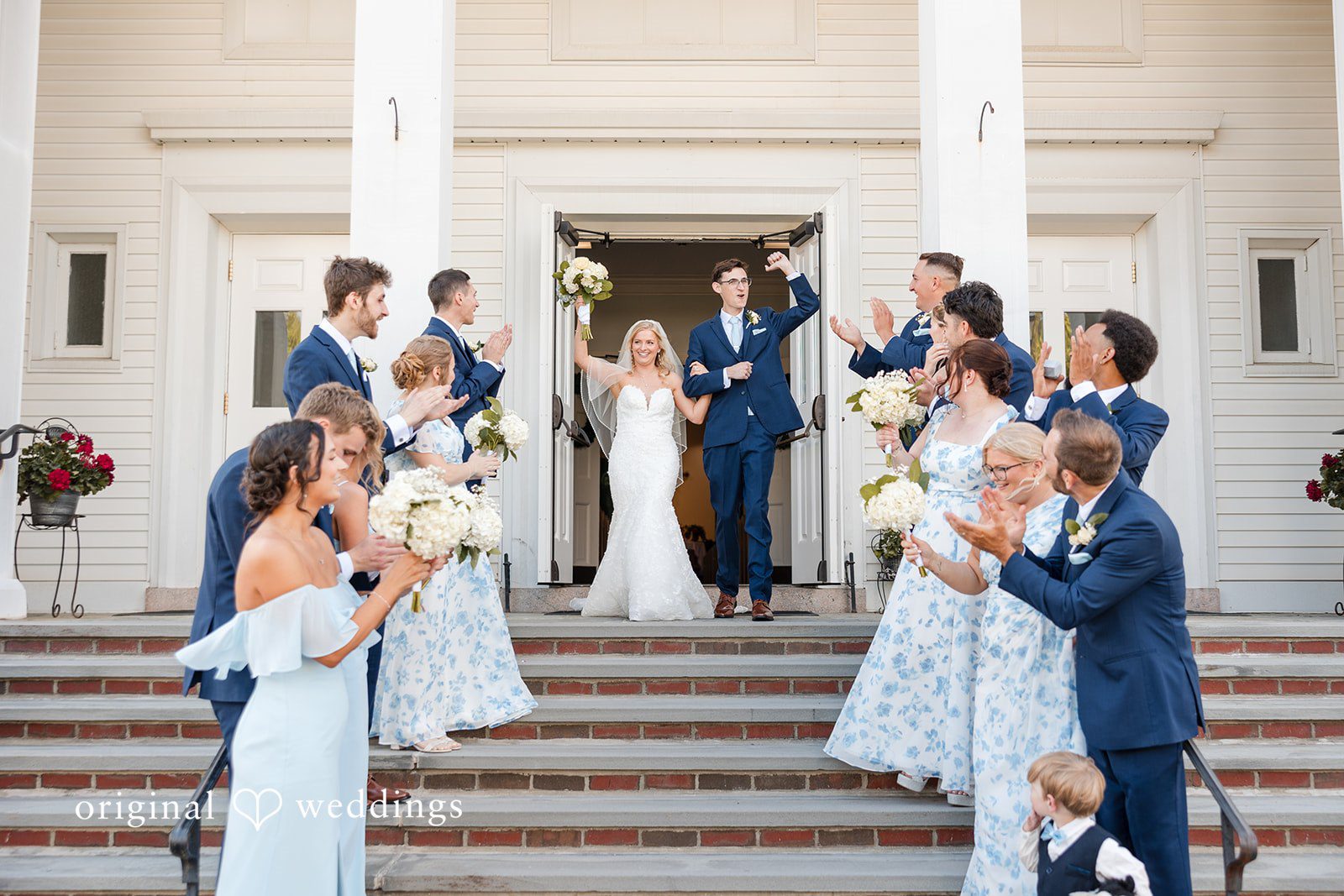 John + Emma Guests tossing flower petals at the couple outside a church.