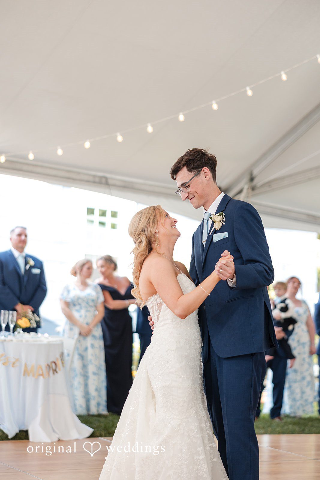 John + Emma Bride and groom dancing together under a reception tent.