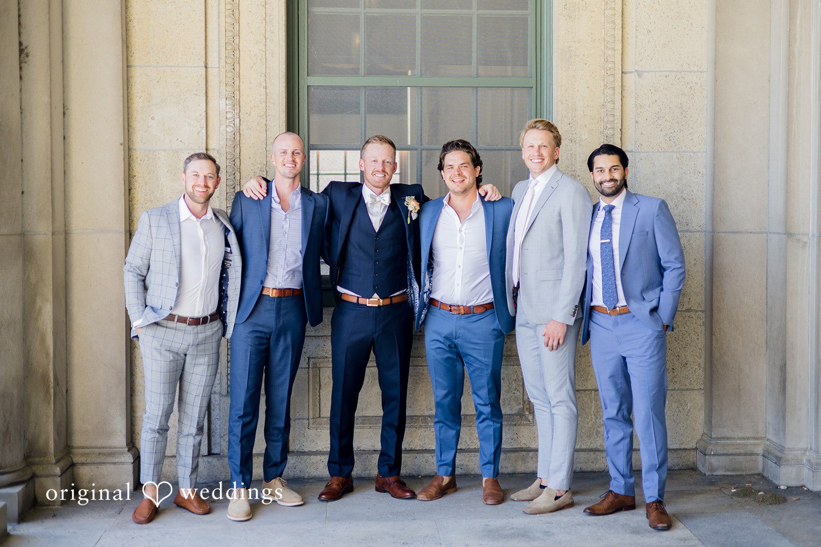 Madison Wedding Photographers documenting groom picture with the groomsmen at Memorial Union by Original Weddings.