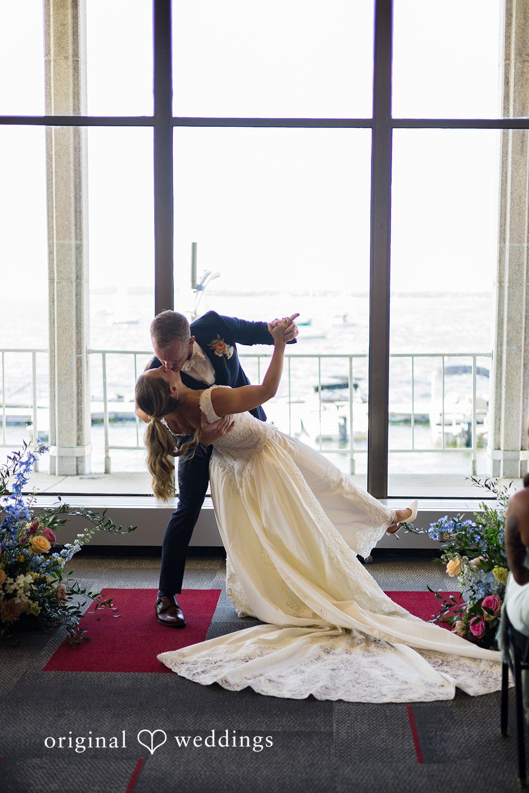 Couple sharing a romantic kiss at Memorial Union captured by Madison Wedding Photographers from Original Weddings.