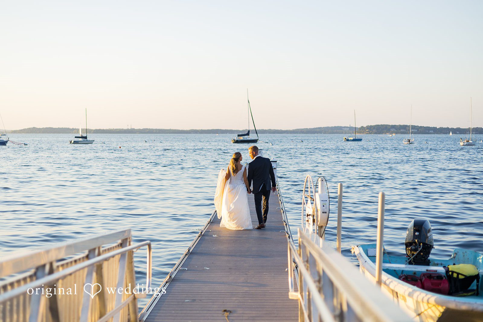 Back view of the bride and groom by the waterfront at Memorial Union captured by Madison Wedding Photographers from Original Weddings.