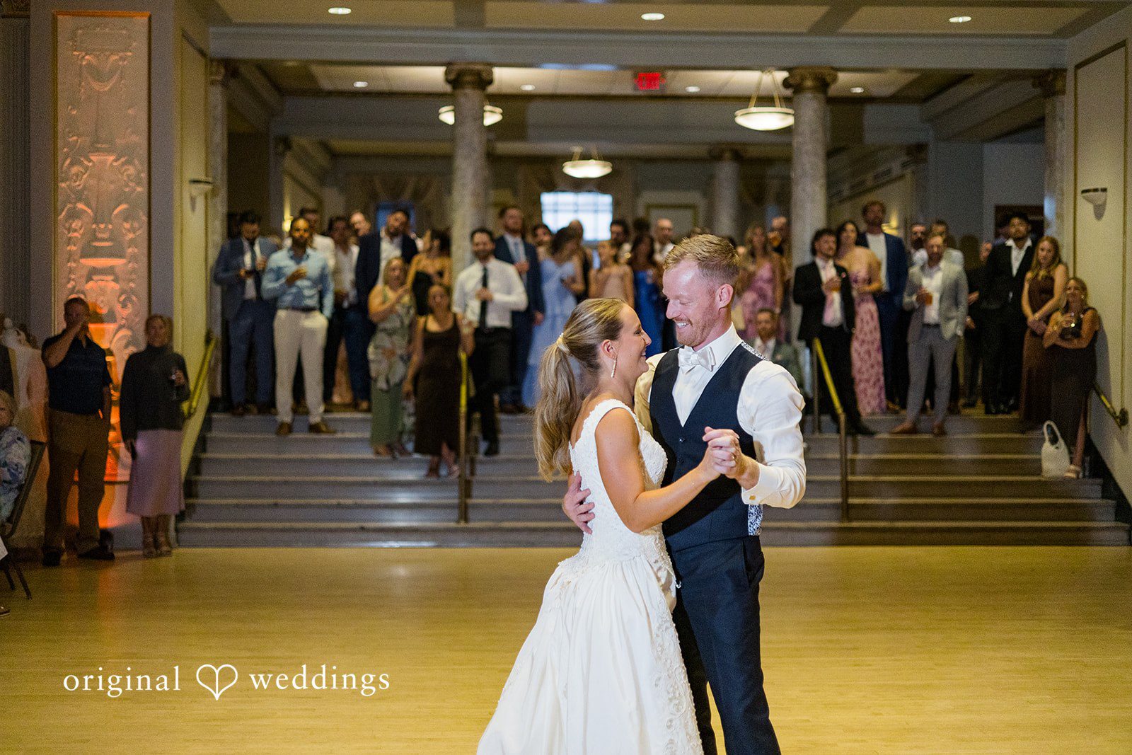 Bride and groom smiling at each other during their wedding dance at Memorial Union.