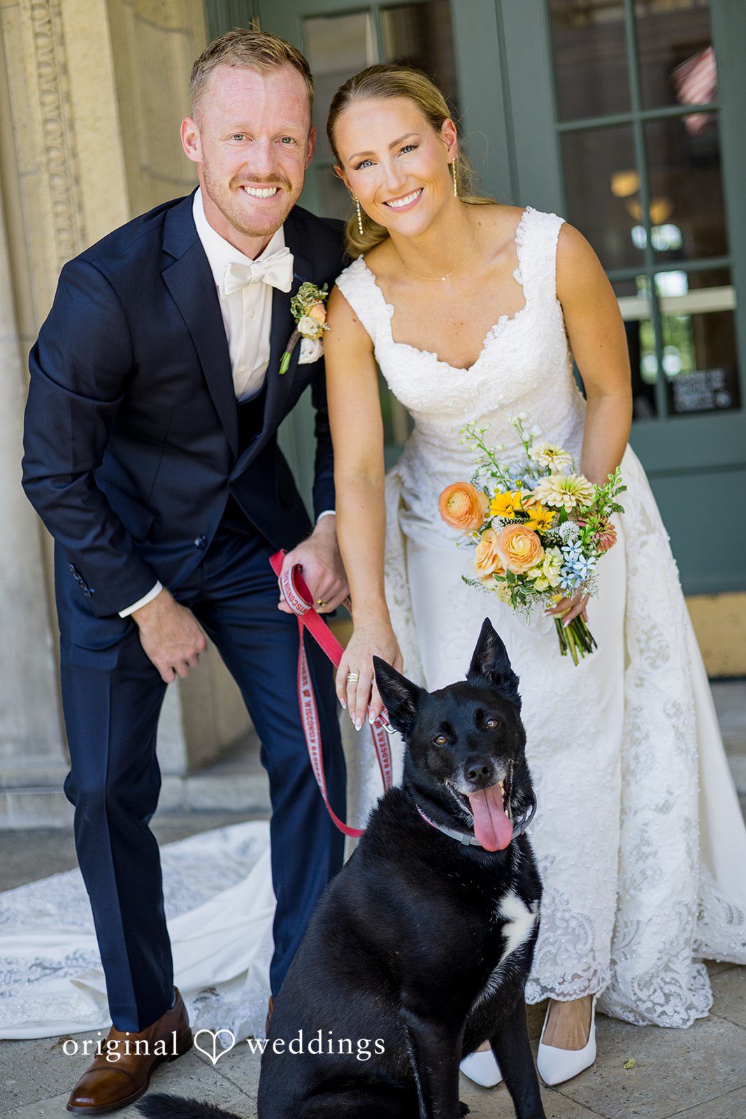 Bride and groom possing together with their puppy  at Memorial Union.