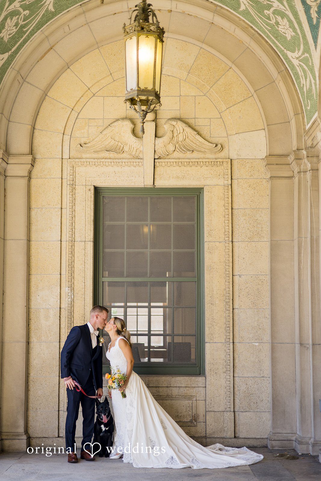 Romantic kiss moment of the couple at Memorial Union captured by Madison Wedding Photographers from Original Weddings.