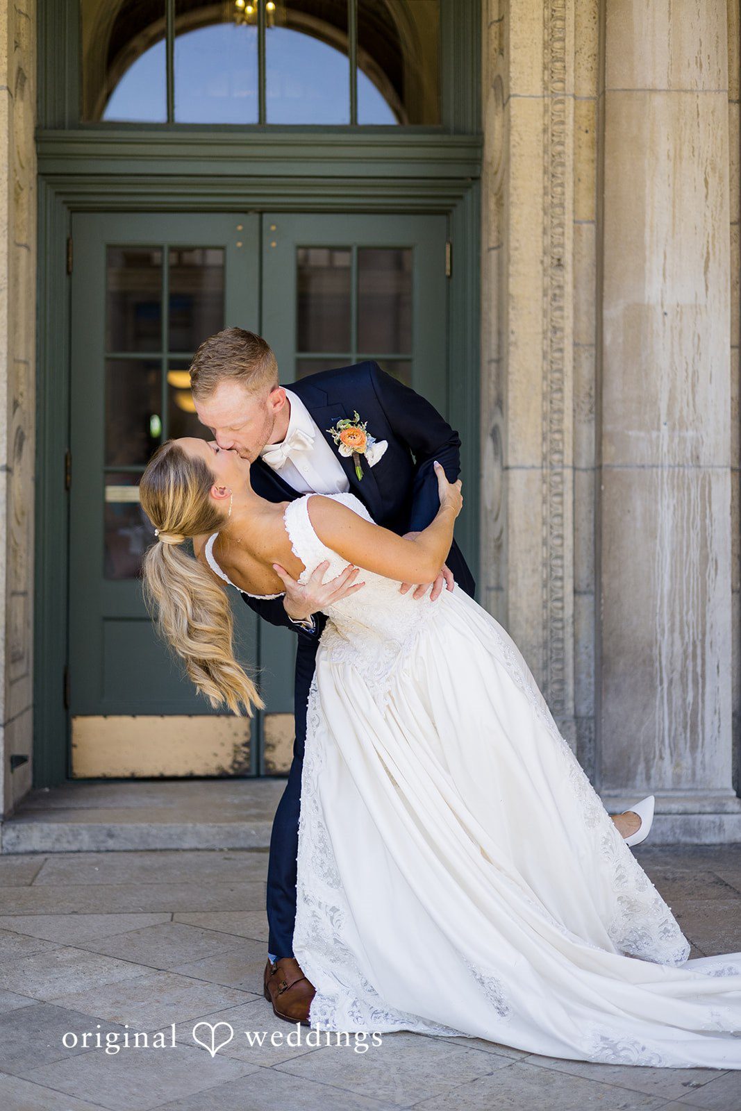 Bride and Groom Sharing a Romantic Lift and Kiss at Memorial Union